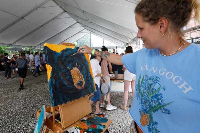 Reneé Royal live paints a bear at FoxSaid Festival at the Cotton Press in Athens, Ga., on Saturday, July 27, 2024. The art and music festival featured interactive art with a number of local artists and raised money for art education in local schools.