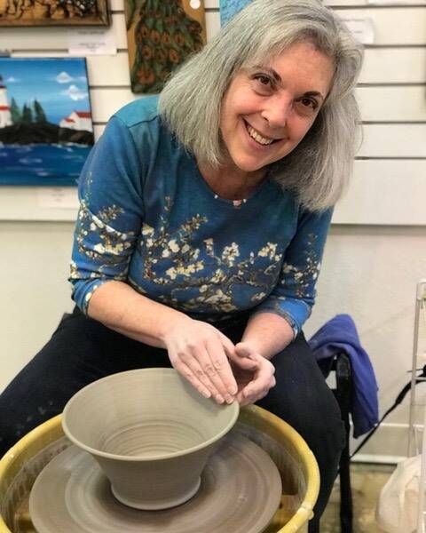 Photo courtesy of Janet Piccola / Potter Janet Piccola, pictured here at the wheel, is one of the featured artists at the Blue Whole Gallery in August, along with Jolene Sanborn.