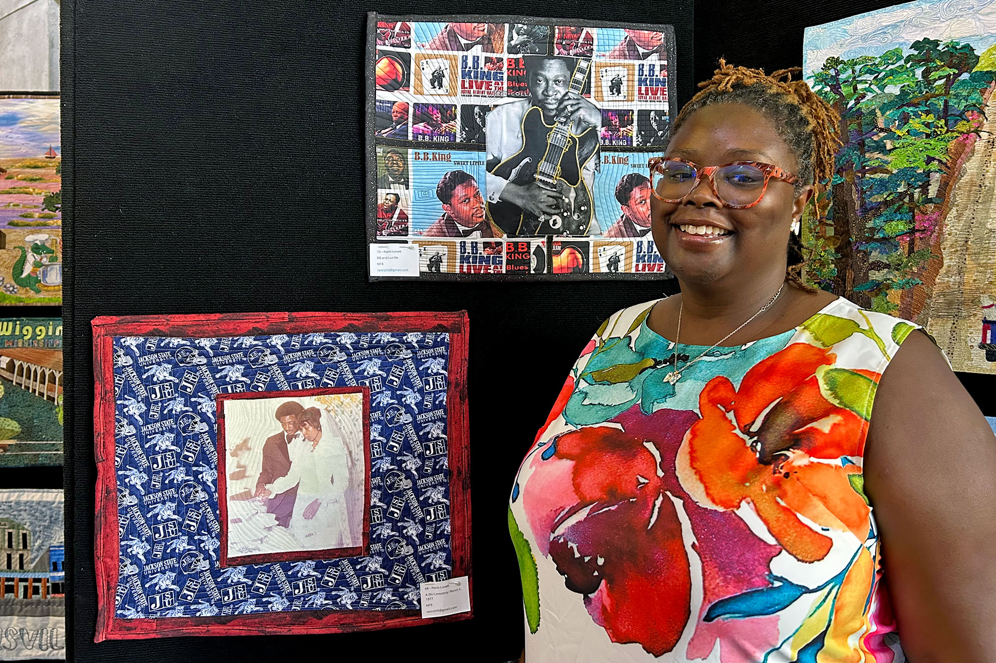 A woman stands in front of two quilted art pieces, one with BB King and the other showing an old wedding photo