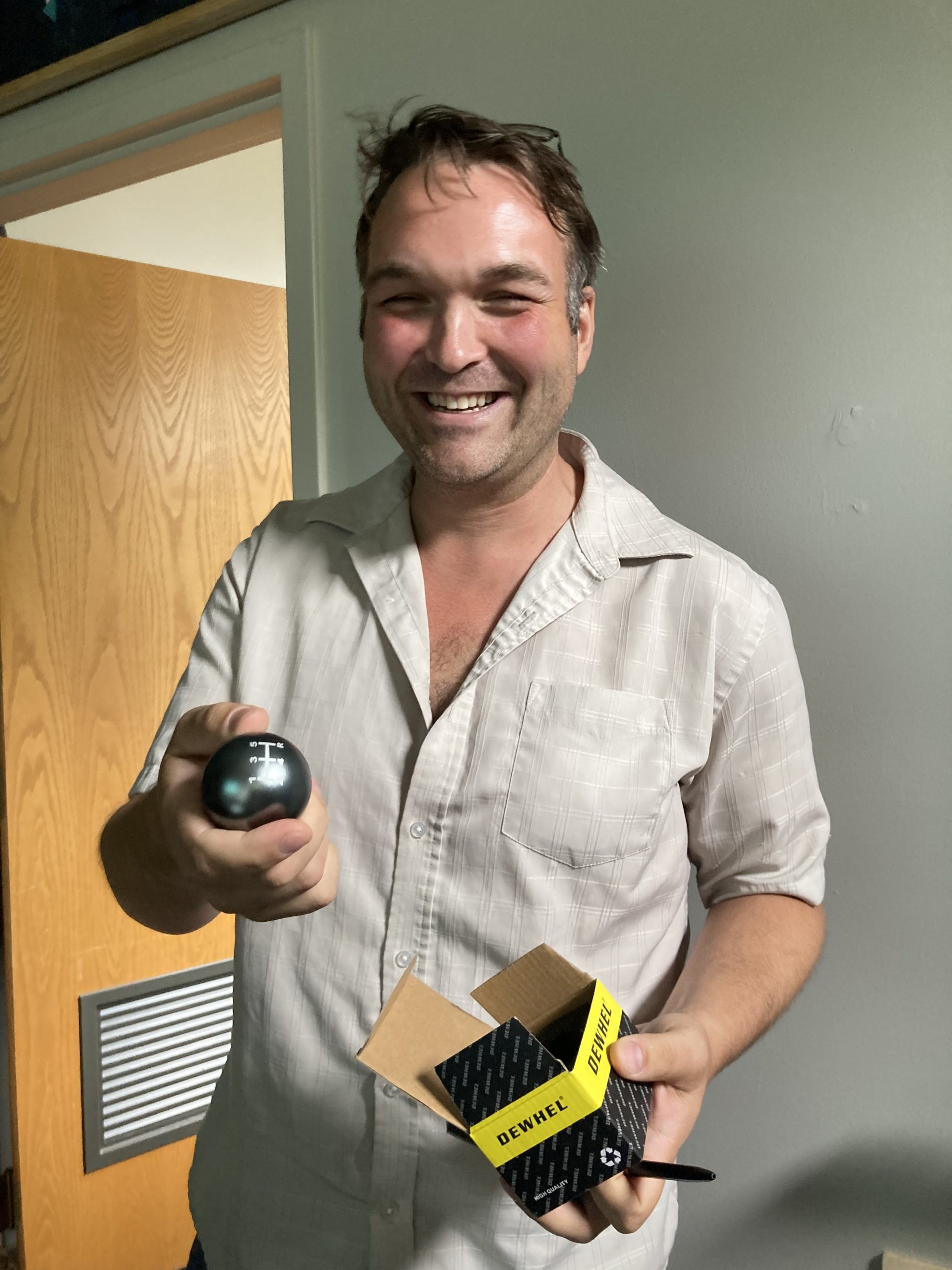 smiling man holding knob and box