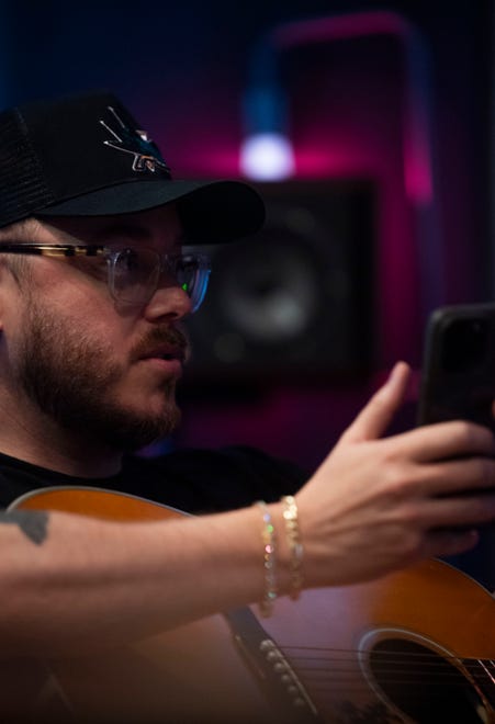 Music Producer, Ned Cameron, talks to Jacob Hackworth while they works at his at his studio in Madison, Tenn., Thursday, July 11, 2024.