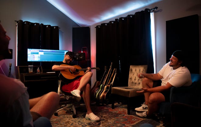 Music Producer, Ned Cameron, laughs with Chase Wright and Jacob Hackworth while they works at his at his studio in Madison , Tenn., Thursday, July 11, 2024.