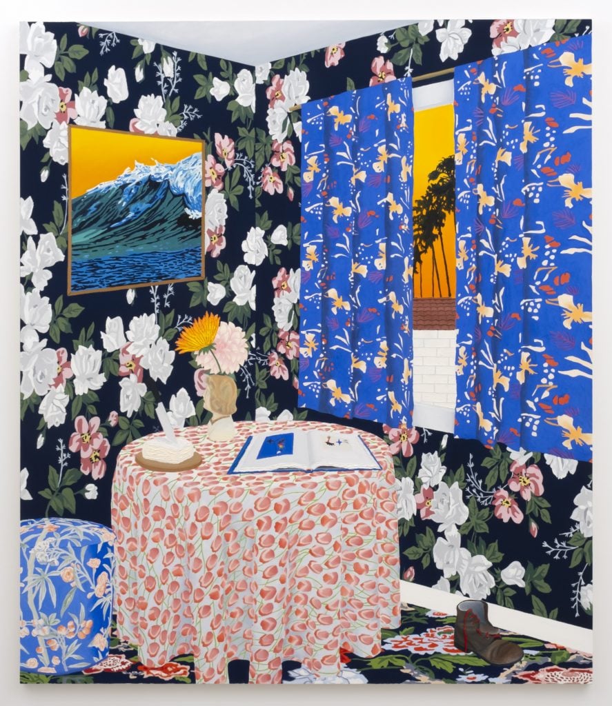 The corner of a room in a Contemporary Intimist style with wallpaper showing photorealistic white floral pattern, a window with an abstracted floral pattern on blue, and a round table with a tulip patterned tablecloth with an open book on miro open, beside an ottoman with blue and pale pink floral upholstery. A slit in the curtains show an ombré orange sky and the silhouette of a palm tree.