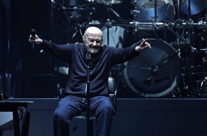 British singer Phil Collins (C) performs on stage during "The last domino" tour of the British rock band Genesis at the Paris La Defense Arena, in Nanterre, northeastern France, on March 16, 2022.