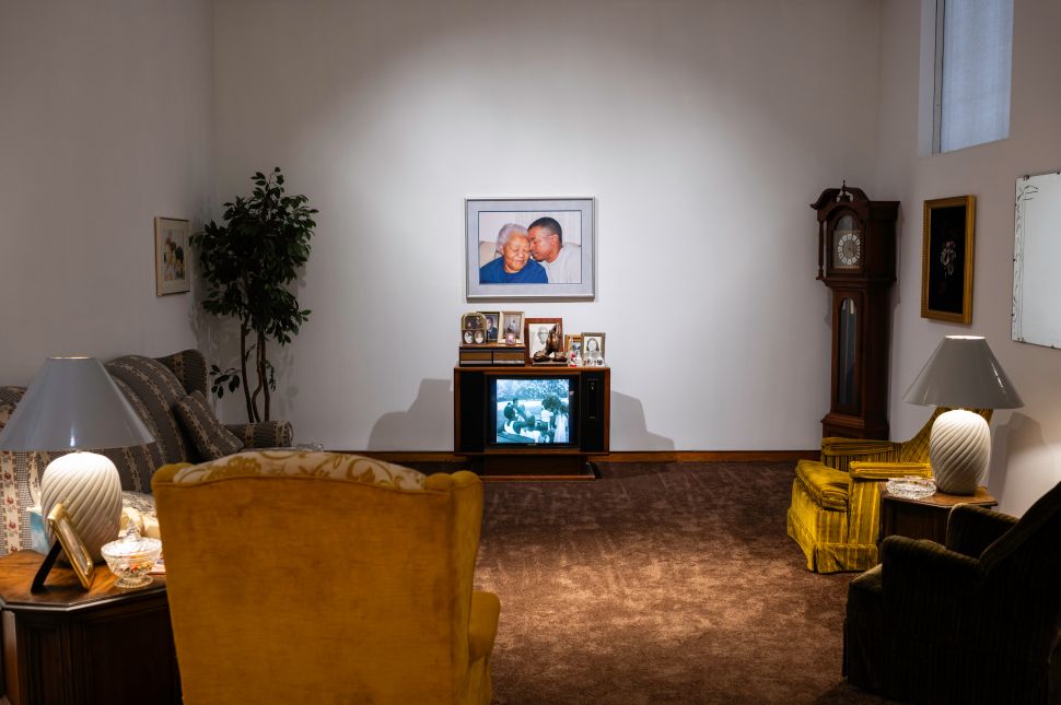 A gallery installation that looks like a 1980s living room