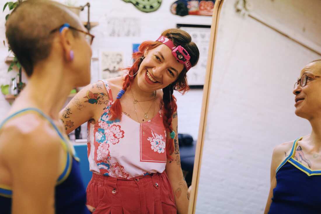 Tattoo artist Sara Sremac show her returning client E Barnick their new tattoo at Nice Try tattoo in Brooklyn, New York on Aug 7, 2024.