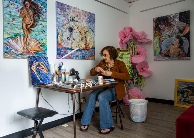 Artist Mary Mindiola works on a new piece of artwork Friday, July 5, 2024, at her studio in Indianapolis. Mindiola creates detailed work made from cut magazine paper after a trip to the Cayman Islands, where she found a large amount of single-use plastic along the beach shoreline.