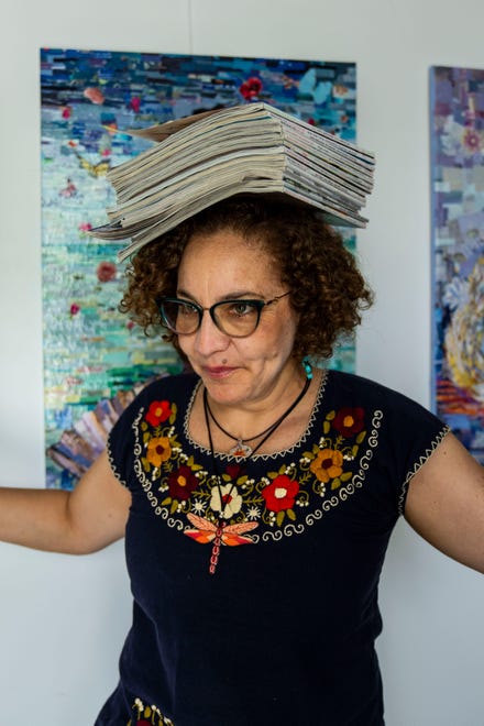 Artist Mary Mindiola balances magazines on her head Friday, July 5, 2024, at her studio in Indianapolis. Mindiola creates detailed work made from cut magazine paper after a trip to the Cayman Islands, where she found a large amount of single-use plastic along the beach shoreline.