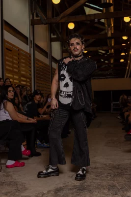 A model wears a Misfits shirt with a jacket over one shoulder.