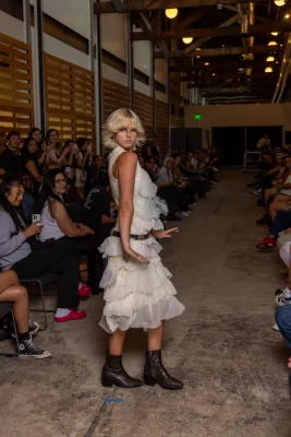 A model wears a white tulle outfit designed by Trung Q. Tham.