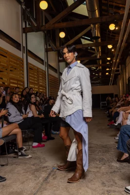 A model wears reworked blue dress clothes designed by Trung Q. Tham.