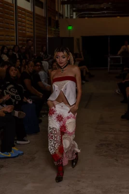 A model wears a red and white tube top with matching pants.