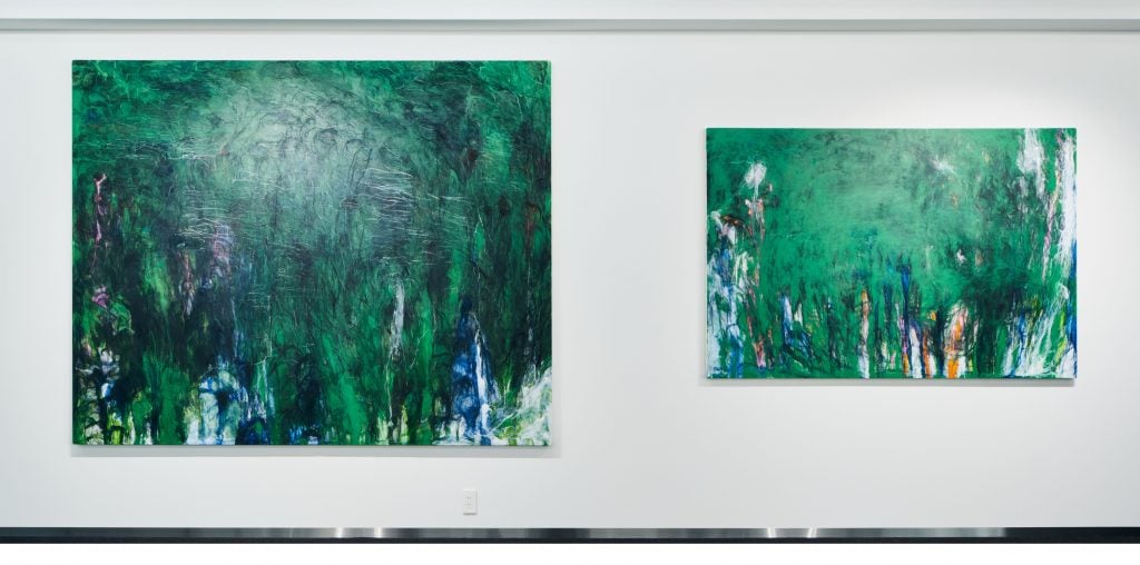 Two green paintings, the left one is bigger than the right one.