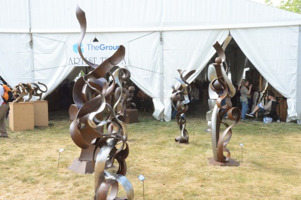 Four sculptures designed by Tucson, Ariz. based artist Steve Grater sit in front of one of the four tents at Benson Sculpture Park during the 40th annual of the Sculpture in the Park Show and Sale on Saturday. (Riley Laub / Loveland Reporter-Herald)