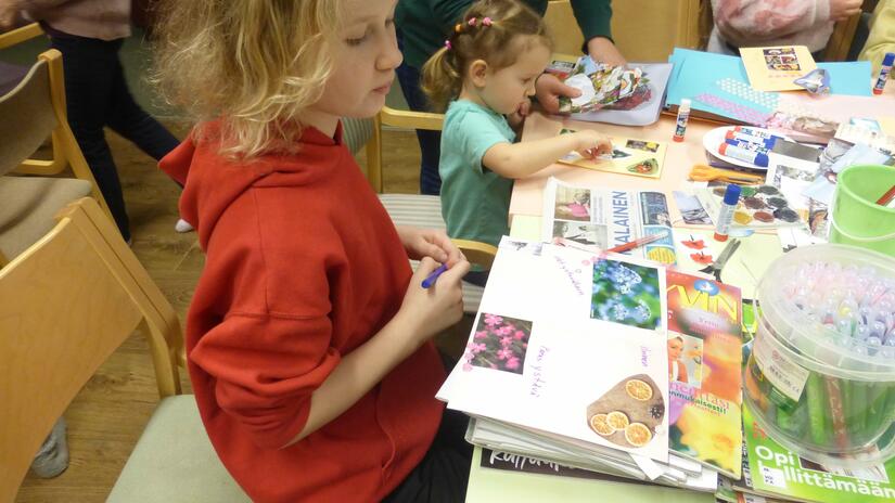 Using coloured pencils, markers and images cut from magazines, children make colorful greeting and thank-you cards as part of an art therapy project for Ukrainian children run by the Finnish Red Cross.